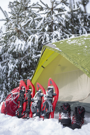Camping in the winter campaign of winter with snowshoes and tent.の写真素材
