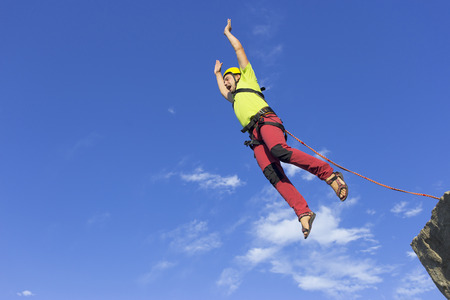 The first jump off the cliff with a safety rope.の写真素材