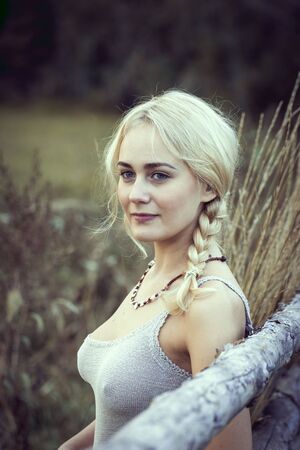 Beautiful blonde girl in the countryside.の写真素材