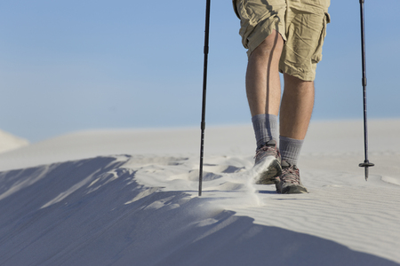 The journey in the desert dunes with white on a backpack.の写真素材