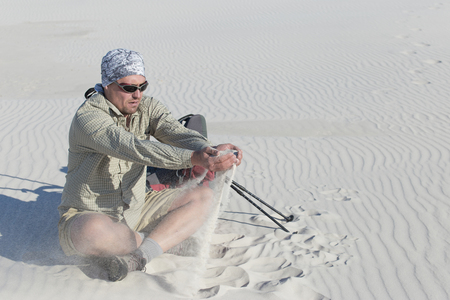 The journey in the desert dunes with white on a backpack.の写真素材