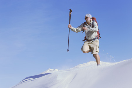 The journey in the desert dunes with white on a backpack.の写真素材
