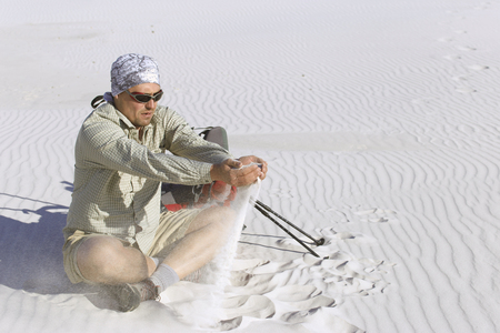 The journey in the desert dunes with white on a backpack.の写真素材