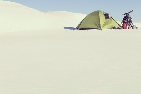 Travel through the desert with a backpack and tent.