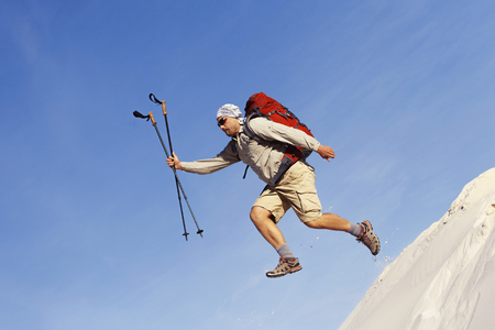 The journey in the desert dunes with white on a backpack.の写真素材