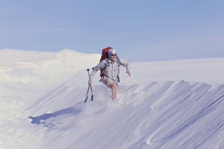 The journey in the desert dunes with white on a backpack.の写真素材