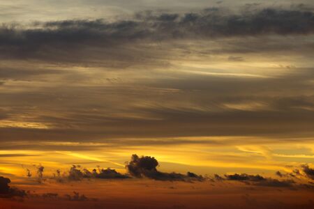 Beautiful sunrise red sun in the clouds.の写真素材