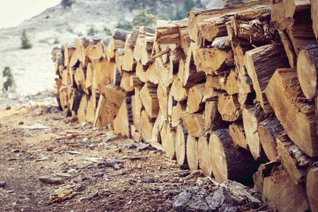 A lot of firewood stacked and ready for use.の写真素材