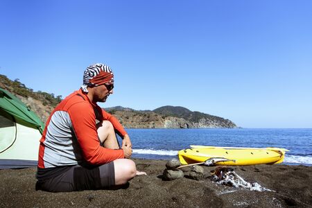 Camping with kayaks on the beach in the summer on a sunny day.の写真素材