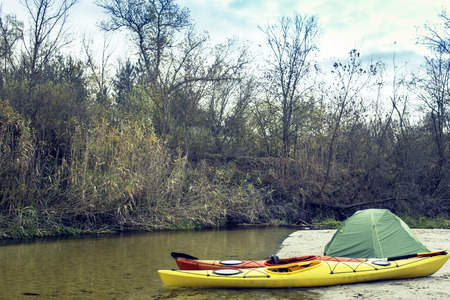 Camping with kayaks on the beach on a sunny day.の写真素材