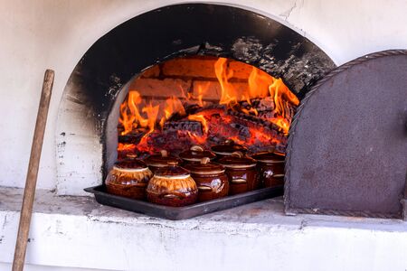 wood-burning stove with food in potsの写真素材