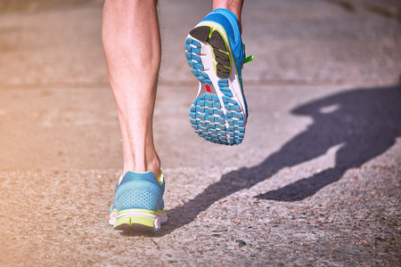 Running athlete during training outdoors in the summer on a sunny day.