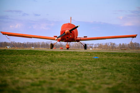Small  aircraft with a propeller in the parking lot of the airfield.