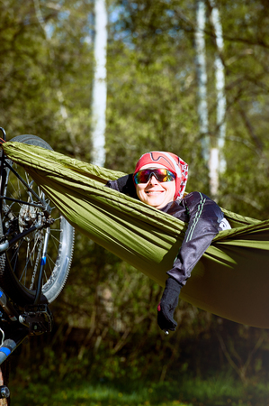 Rest in a hammock after a cycling adventure in the forest.の写真素材
