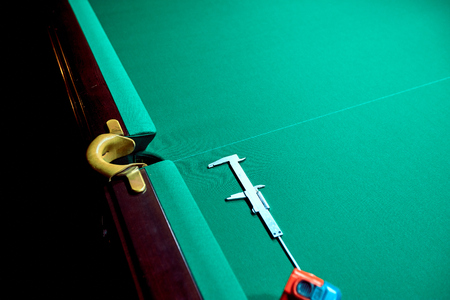 Lighted billiard table green on the service before the game.