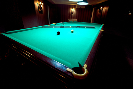 Lighted billiard table green on the service before the game.のeditorial素材