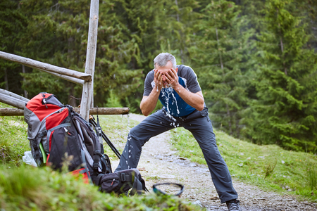 Hiking in the mountains with a backpack in the summer.の写真素材