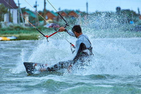 Man riding a kite surfing on the waves in the summer.の写真素材