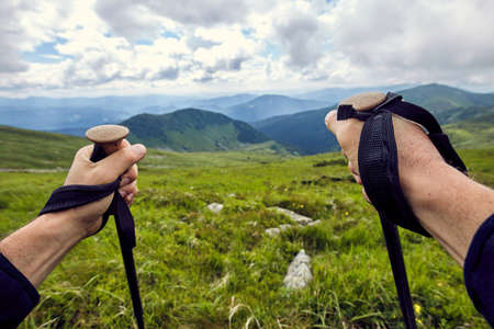 Hiking in the mountains with a backpack in the summer.の写真素材