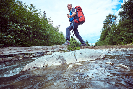 Hiking in the mountains with a backpack in the summer.の写真素材