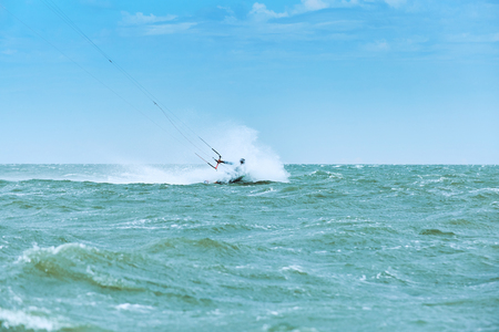 Kite Surfing on waves at sea in summer.の写真素材