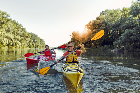 Man paddling in a kayak on river.の写真素材