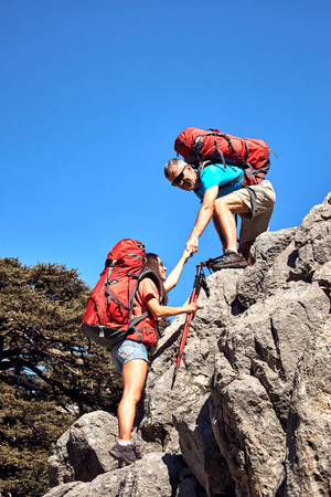 A helping hand high in the mountains in the summer hike.の写真素材