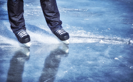 The guy rides on skates on ice in the winter.の写真素材