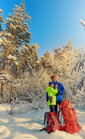 Walk the couple in love on a hike through the winter forest.の写真素材