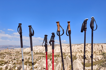 Trekking sticks against the backdrop of the rocky mountains in summer.の写真素材