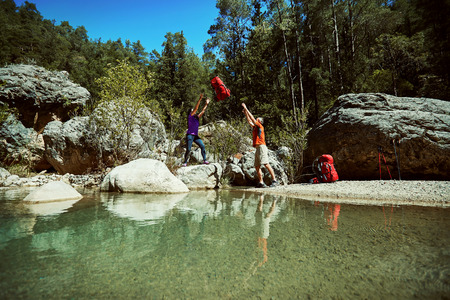 Summer hike in the canyon with a red backpack and tent.の写真素材