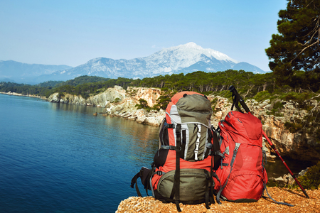 Two backpacks in the camp on a hike along the coast in the summer.の写真素材