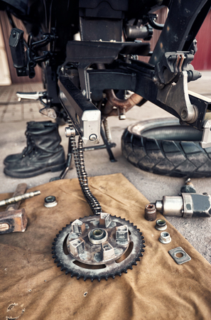 Detail of a motorcycle rear chain with exhaust pipes. Rear view of a motorcycle with the focus on chain.の写真素材