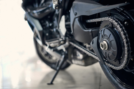 Detail of a motorcycle rear chain with exhaust pipes. Rear view of a motorcycle with the focus on chain.の写真素材