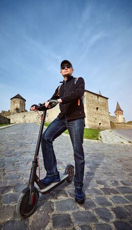 Using an electric scooter as a vehicle in rural areas.の写真素材