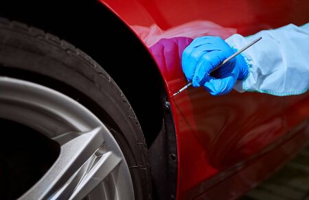 Professional painting of a red car on the serviceの写真素材
