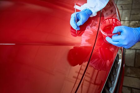 Professional painting of a red car on the serviceの写真素材