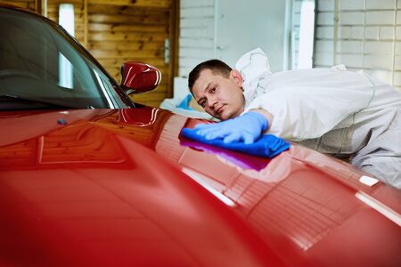 Professional polishing at the service of a red car.の写真素材
