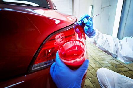 Professional painting of a red car on the serviceの写真素材
