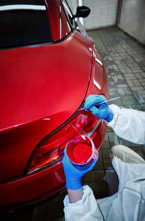Professional painting of a red car on the serviceの写真素材
