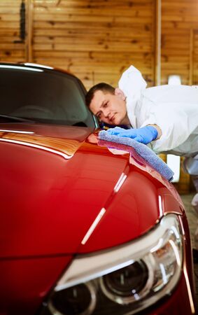 Professional polishing at the service of a red car.の写真素材