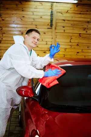 Professional polishing at the service of a red car.の写真素材