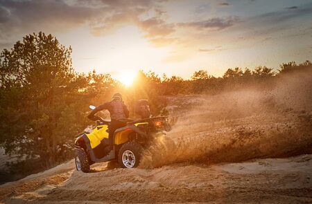 Racing in the sand on a four-wheel drive quad.の写真素材