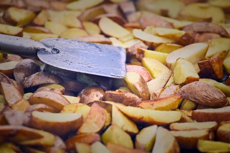 Traditional cooking of fried potatoes in a pan in the countryside.の写真素材