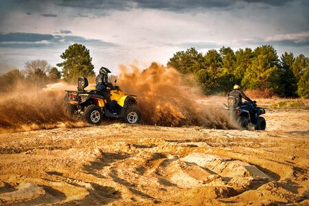 Racing in the sand on a four-wheel drive quad.の写真素材