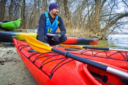 Kayaking along the coast in early spring afternoon.の写真素材