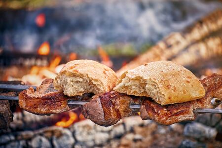 Cooking tasty meat on an open fire in nature.の写真素材