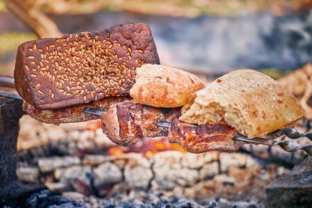 Cooking tasty meat on an open fire in nature.の写真素材