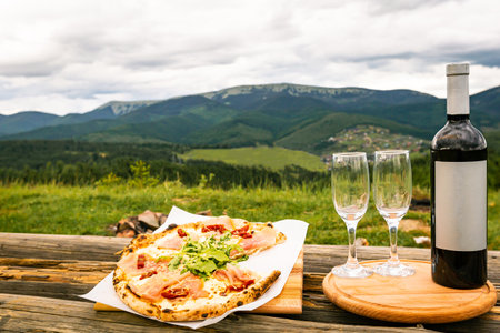 Pizza and wine in nature in a beautiful place.の写真素材