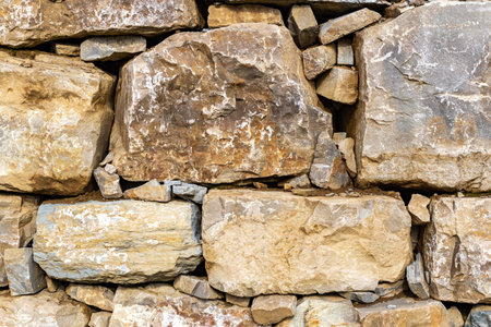 Stone wall fence in daylight. Banner background, backdrop or texture.の写真素材